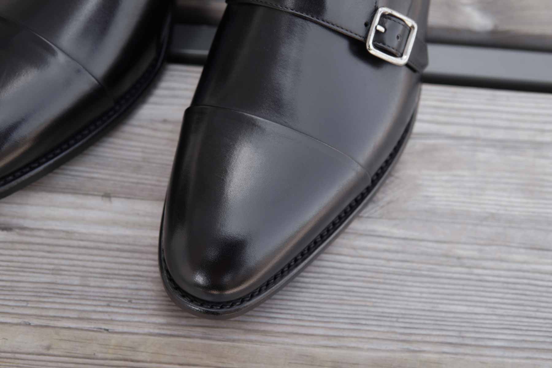 Close-up of Carlos Santos 9975 Reversed Stitched Double Monks in Black Calf, showing the sleek leather and buckle detail.