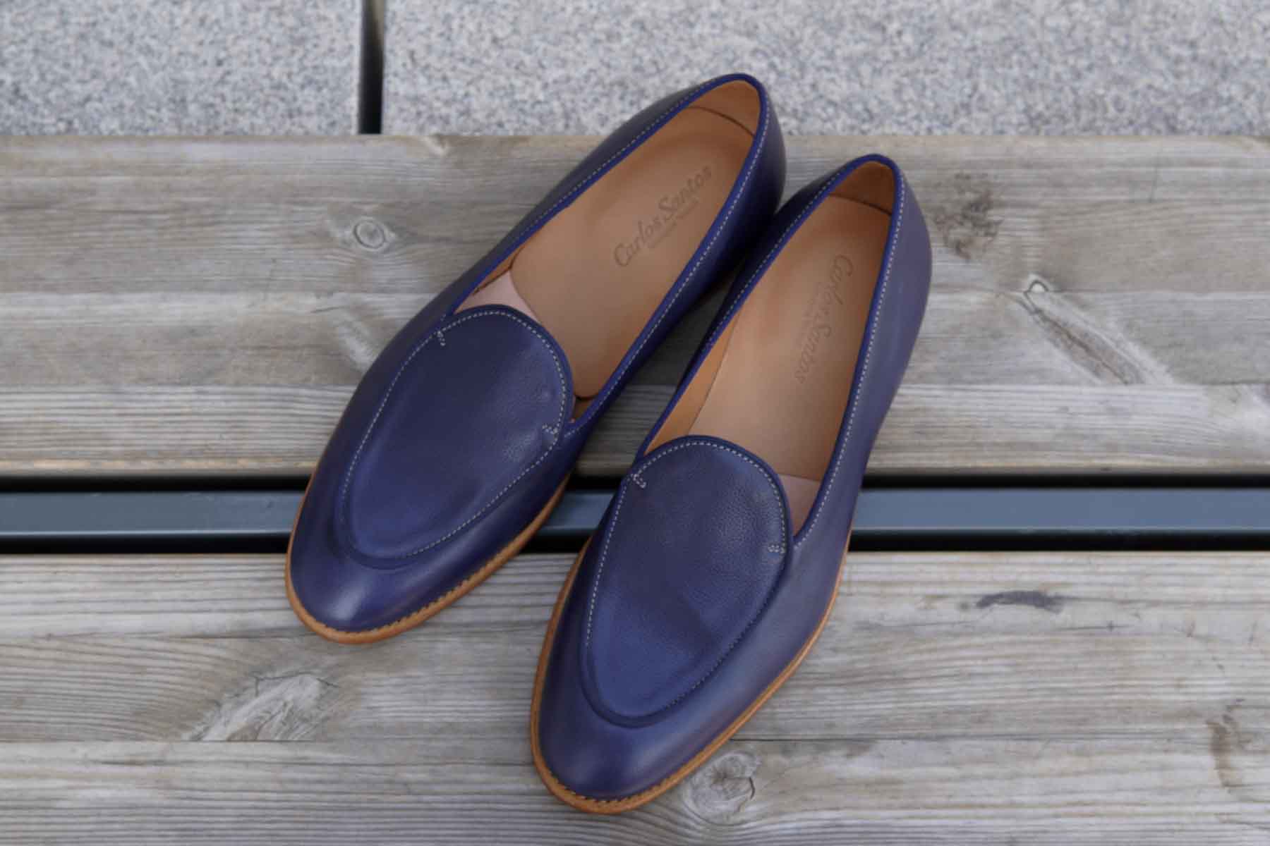 Carlos Santos 1829 Belgian Loafers in Navy Grain on wooden surface